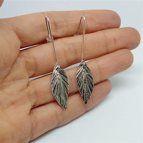 Pendientes pluma negra Continuara.org